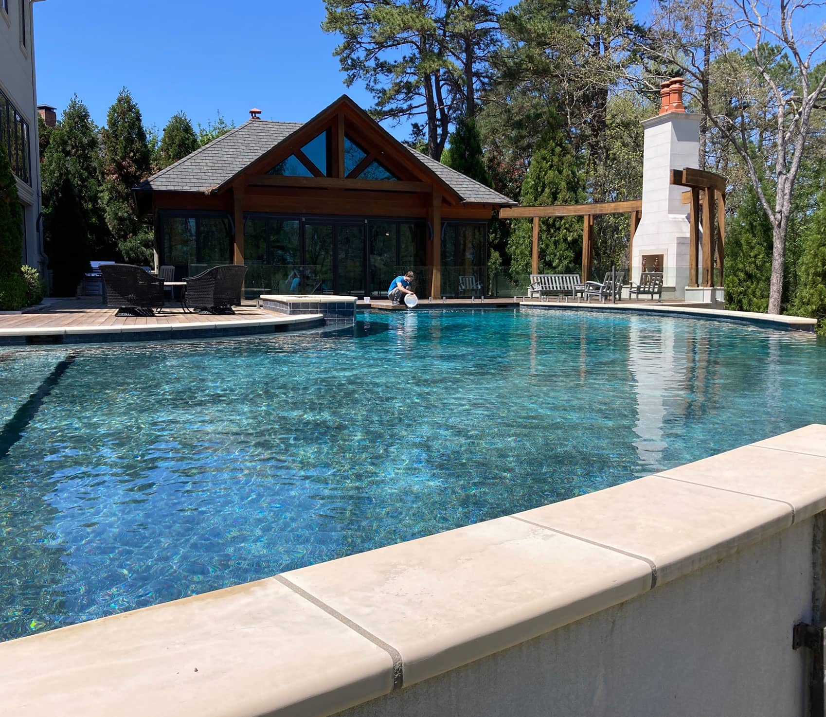 a large pool being maintained by an incredible cleaning employee