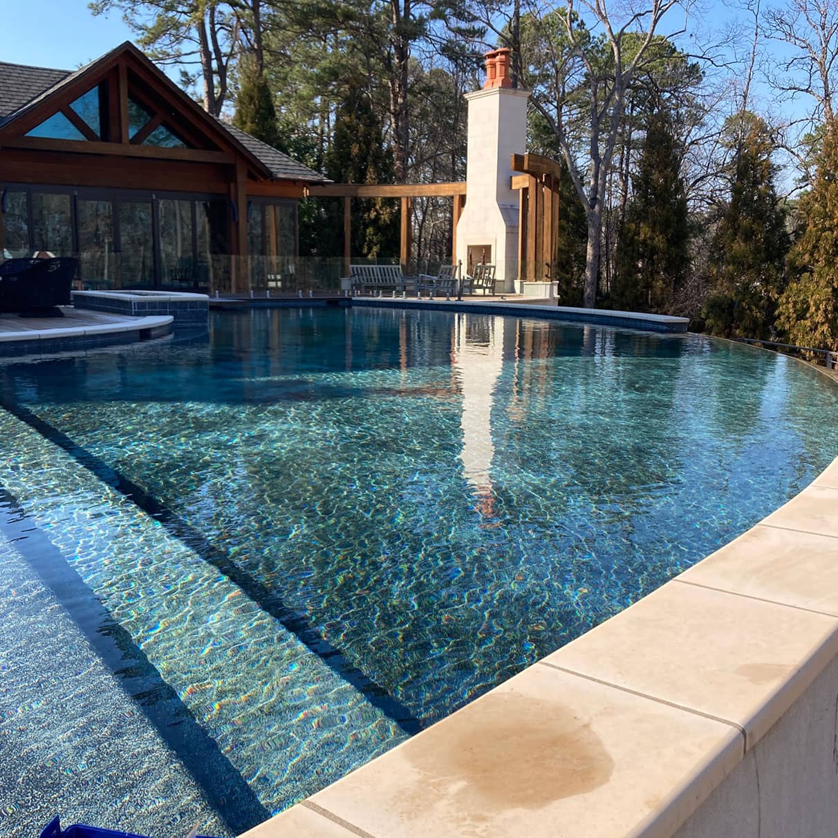 clean pool in the backyard of a very high end house